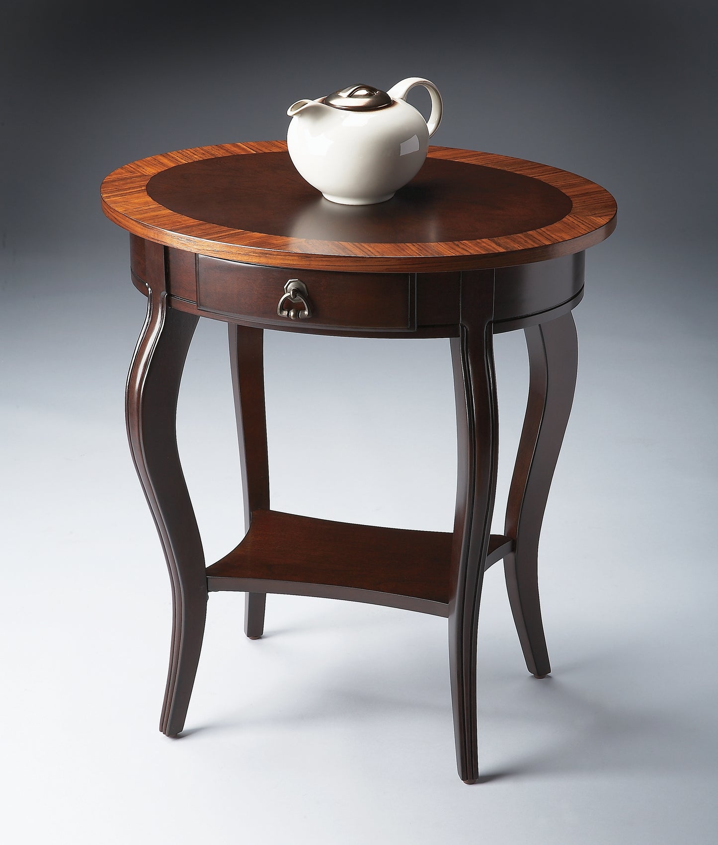 Butler Specialty Company Jeanette 24.5 in. W Oval Wood 1 Drawer Side Table with Lower Open Shelf, Dark Brown