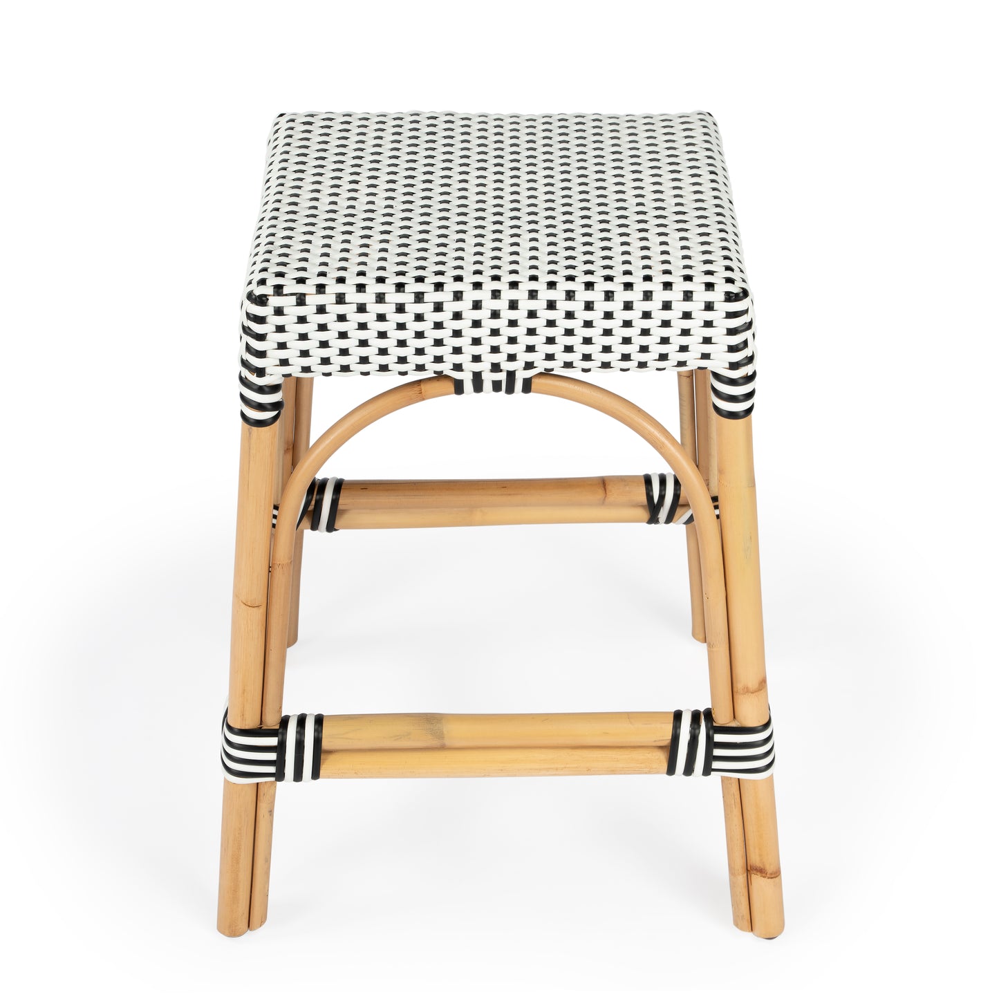 Butler Specialty Company Robias 24.5 in. Seat Height Rectangular Rattan Backless Counter Stool with Footrest, White and Black Dot