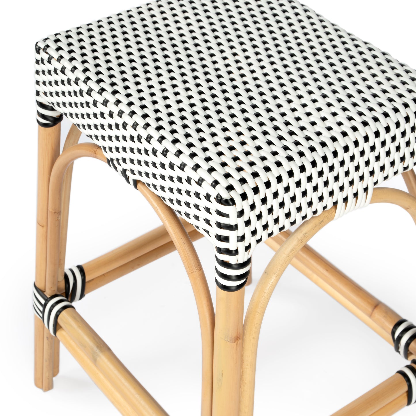Butler Specialty Company Robias 24.5 in. Seat Height Rectangular Rattan Backless Counter Stool with Footrest, White and Black Dot