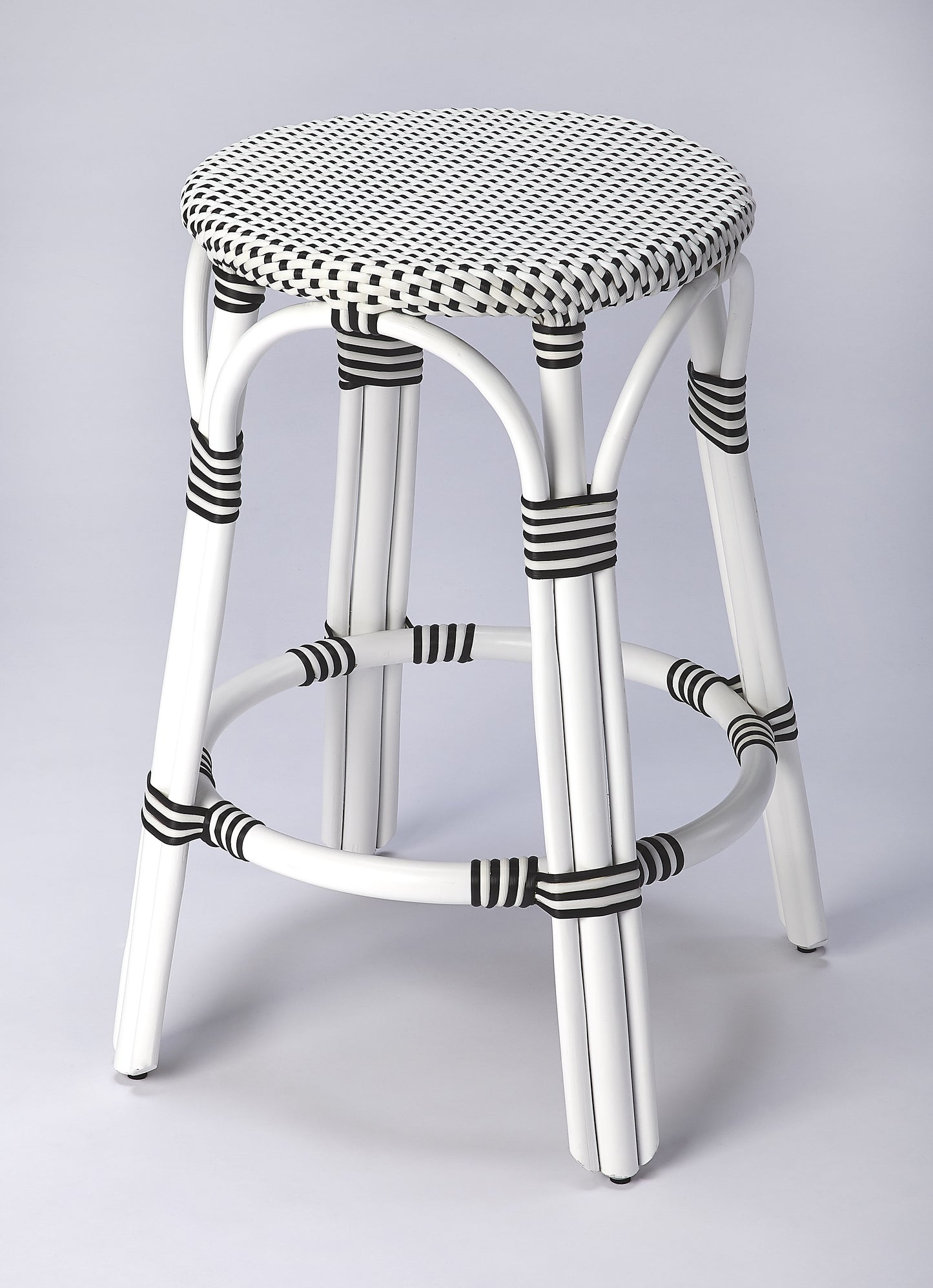 Butler Specialty Company Tobias 24 in. Seat Height Round Rattan Backless Counter Stool, White and Black Dot
