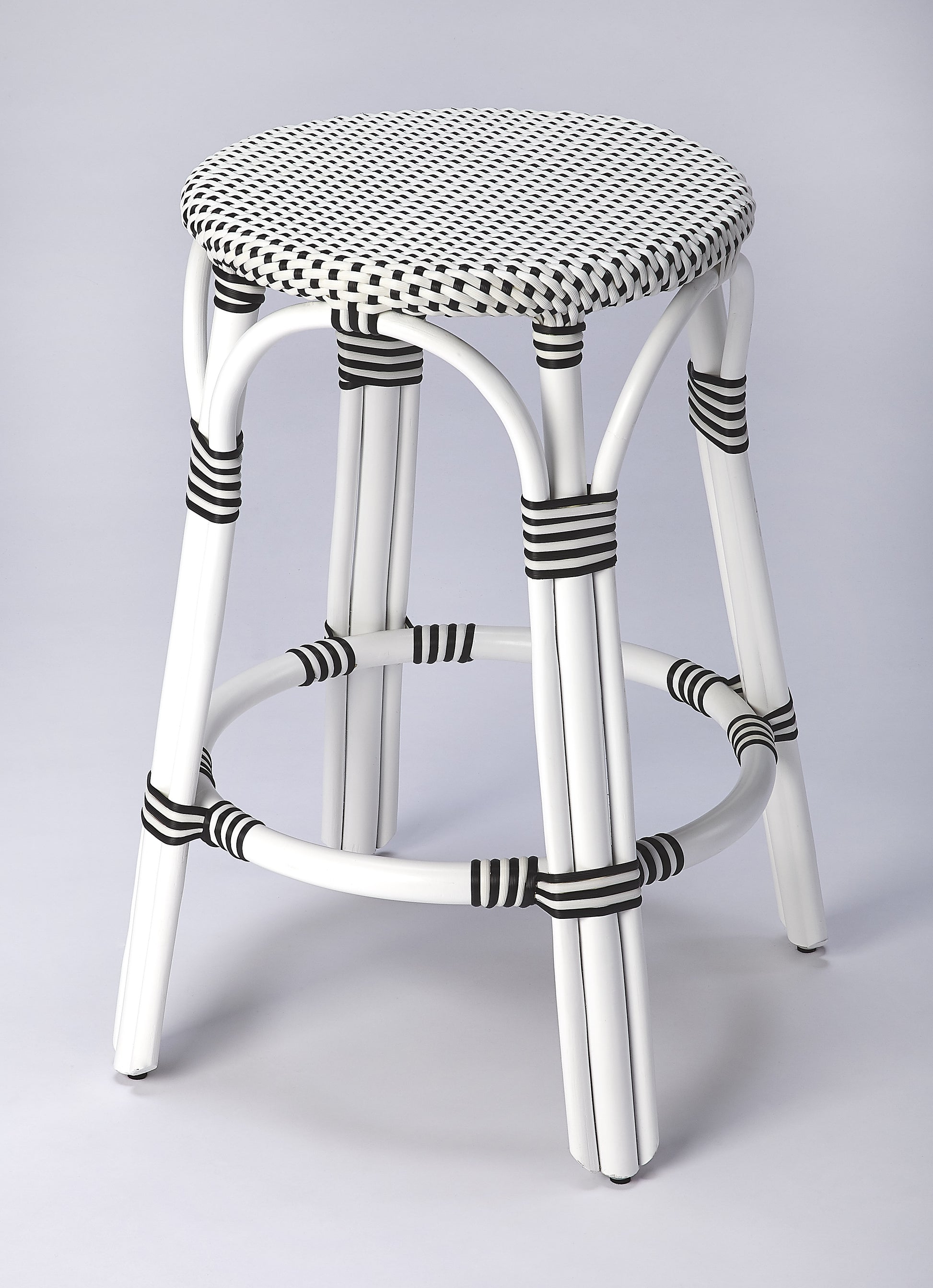 Butler Specialty Company Tobias 24 in. Seat Height Round Rattan Backless Counter Stool, White and Black Dot