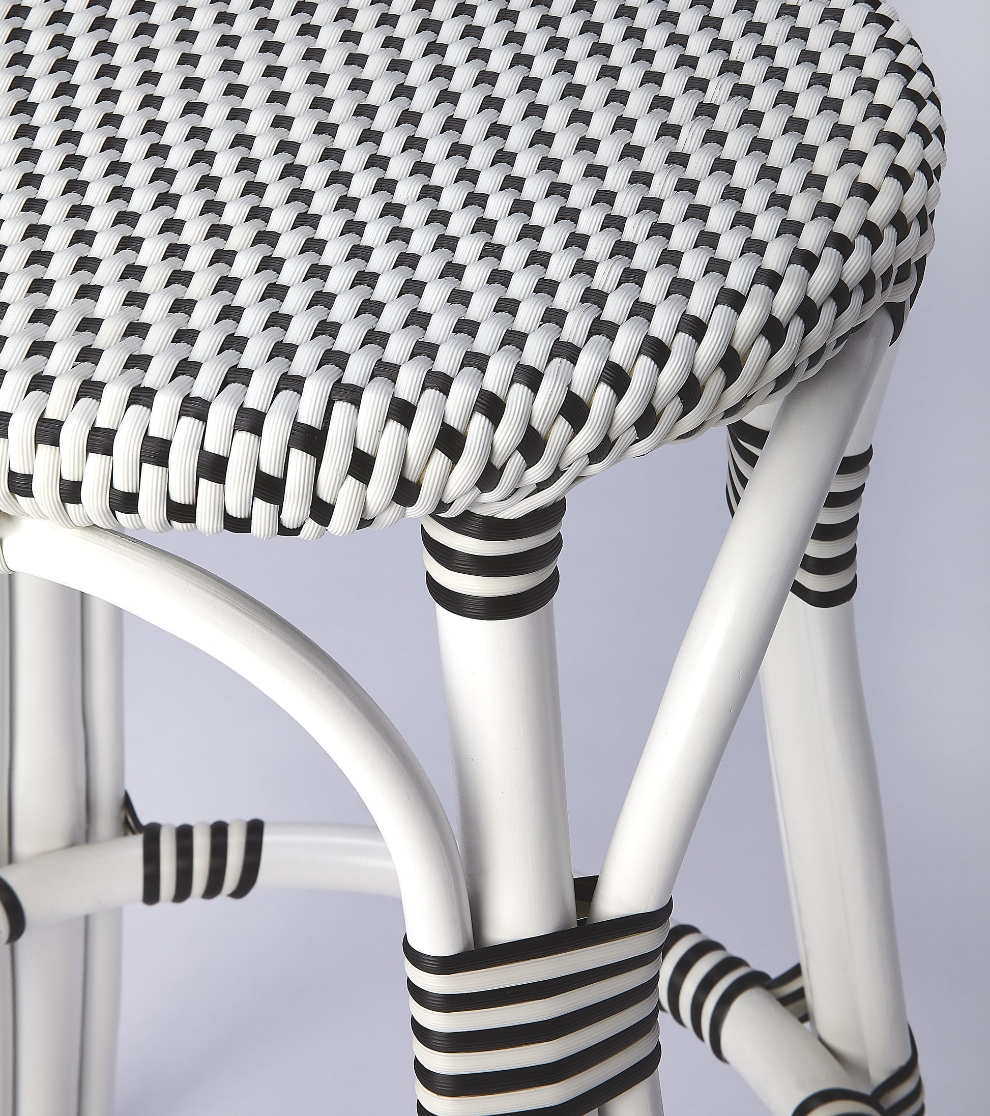 Butler Specialty Company Tobias 24 in. Seat Height Round Rattan Backless Counter Stool, White and Black Dot