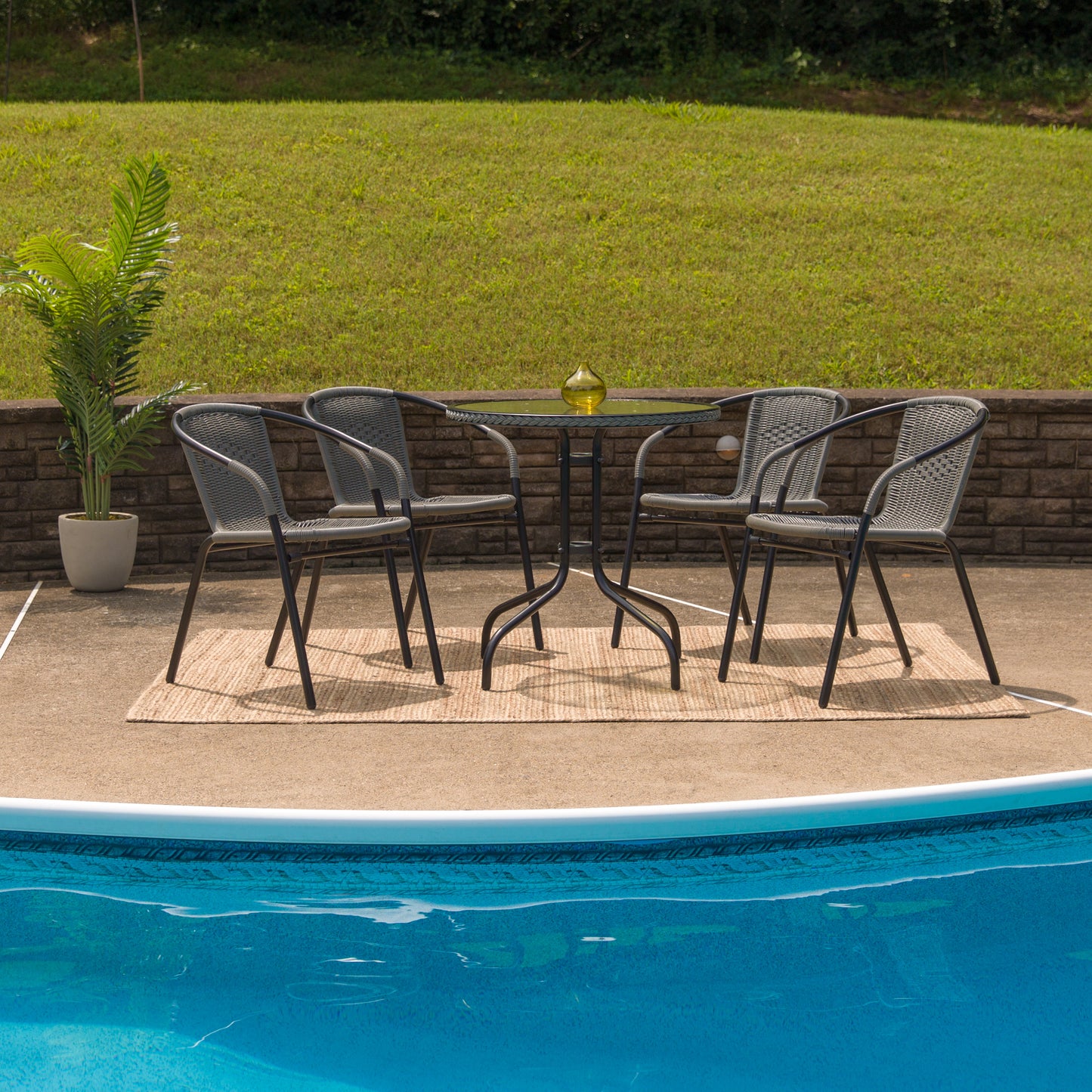 Lila 28'' Round Glass Metal Table with Gray Rattan Edging and 4 Gray Rattan Stack Chairs Gray