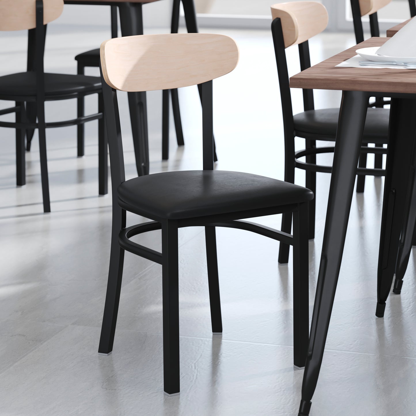 Wright Commercial Dining Chair with 500 LB. Capacity Black Steel Frame, Natural Birch Finish Wooden Boomerang Back, and Black Vinyl Seat Natural Birch Wood Back/Black Vinyl Seat
